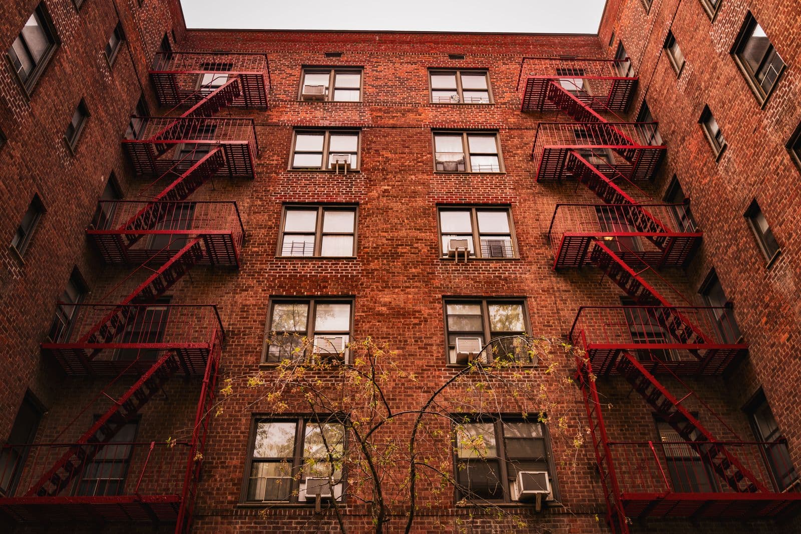 Brick New York apartment building with fire escapes