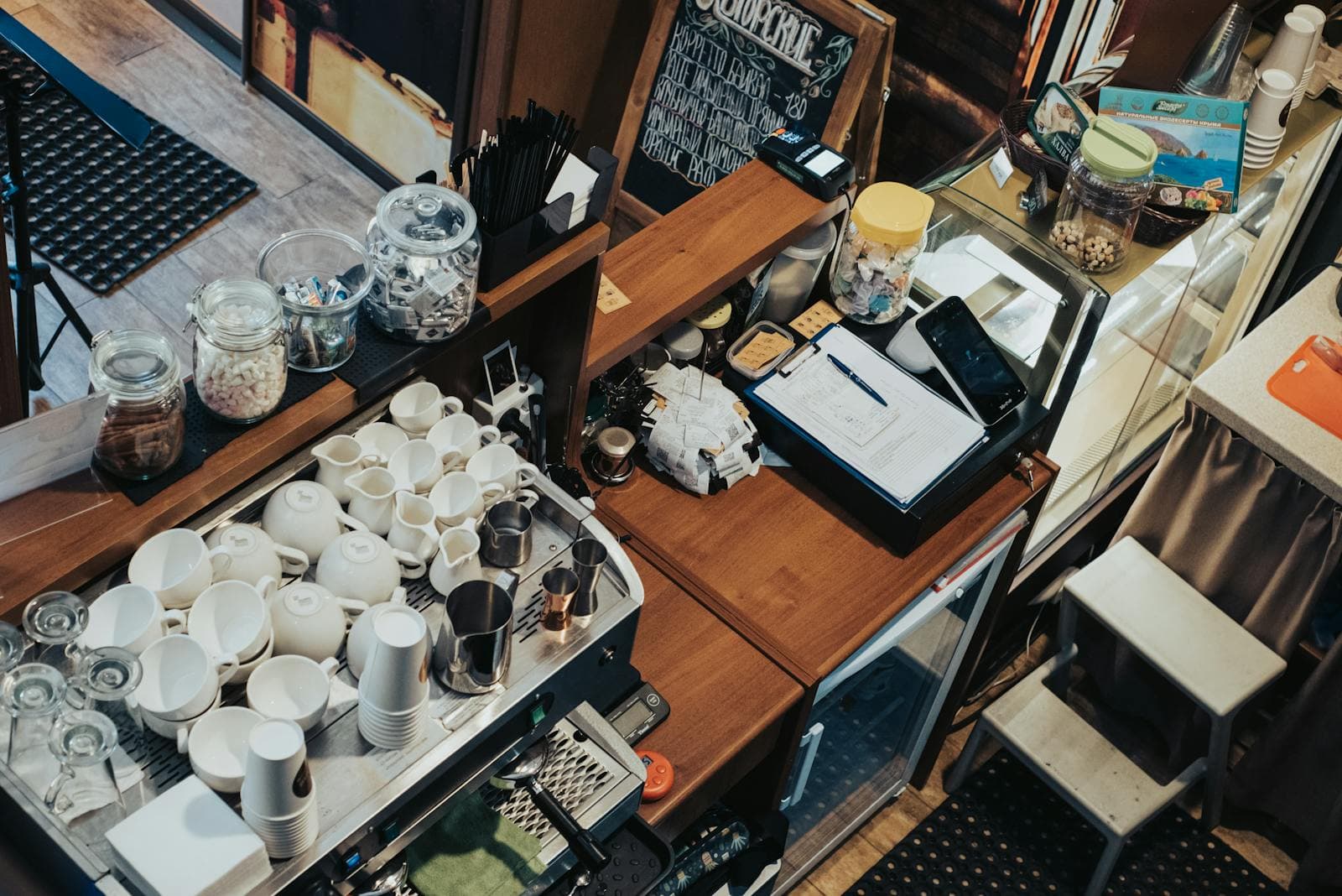 Coffee-shop counter with espresso machine and stacked cups