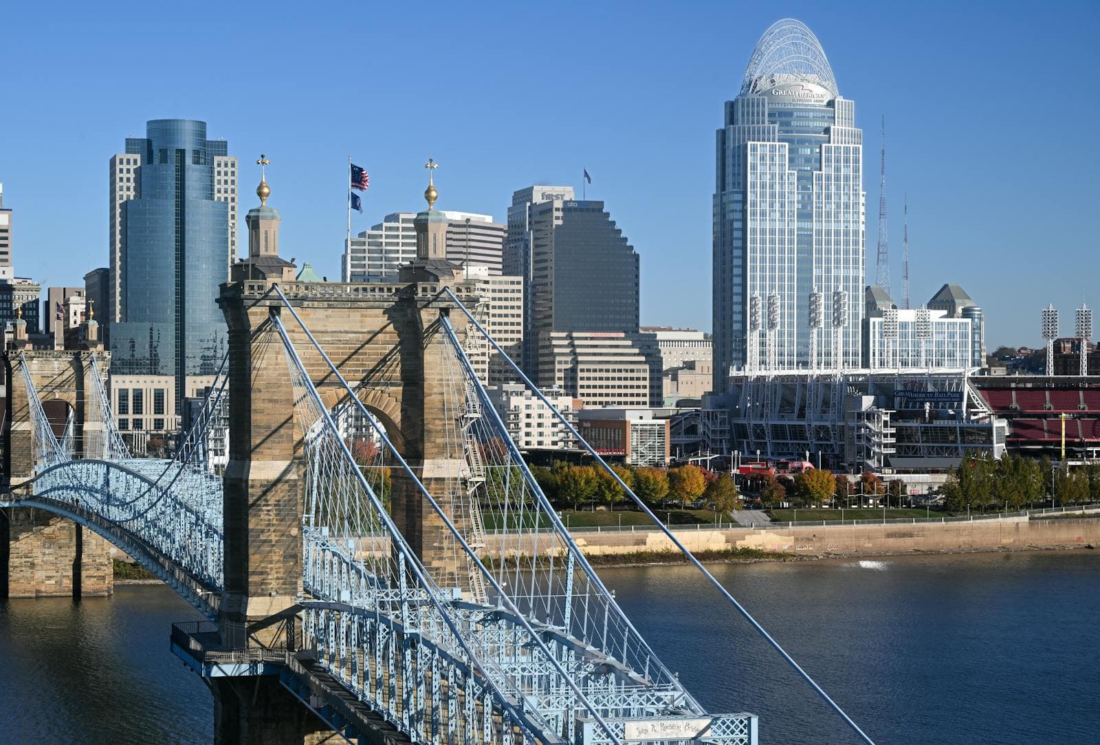 The Cincinnati skyline with the Great American Tower rising behind the historic Roebling Suspension Bridge on the Ohio River.